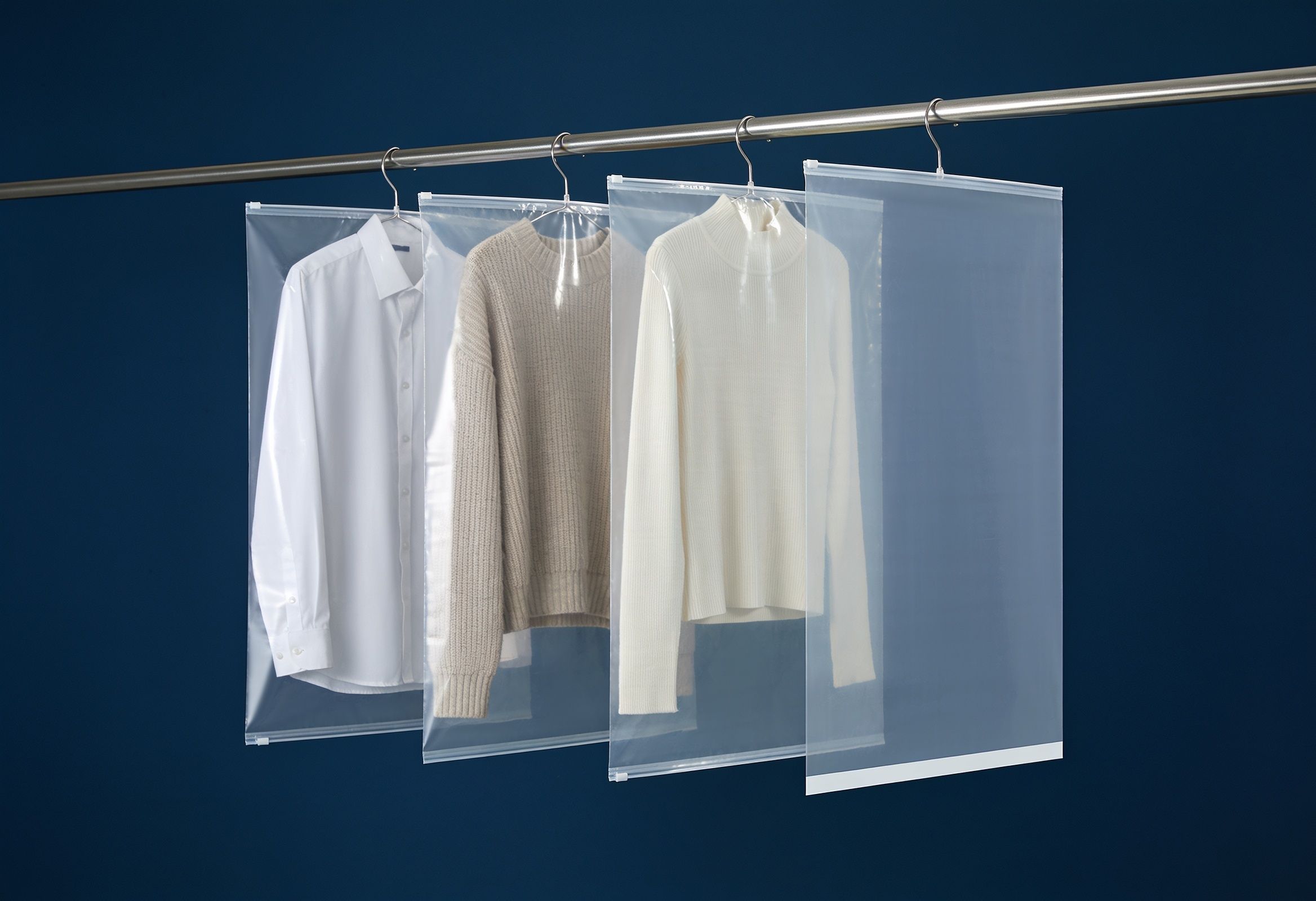 Transparent polyethylene garment covers protecting clothes on a rack